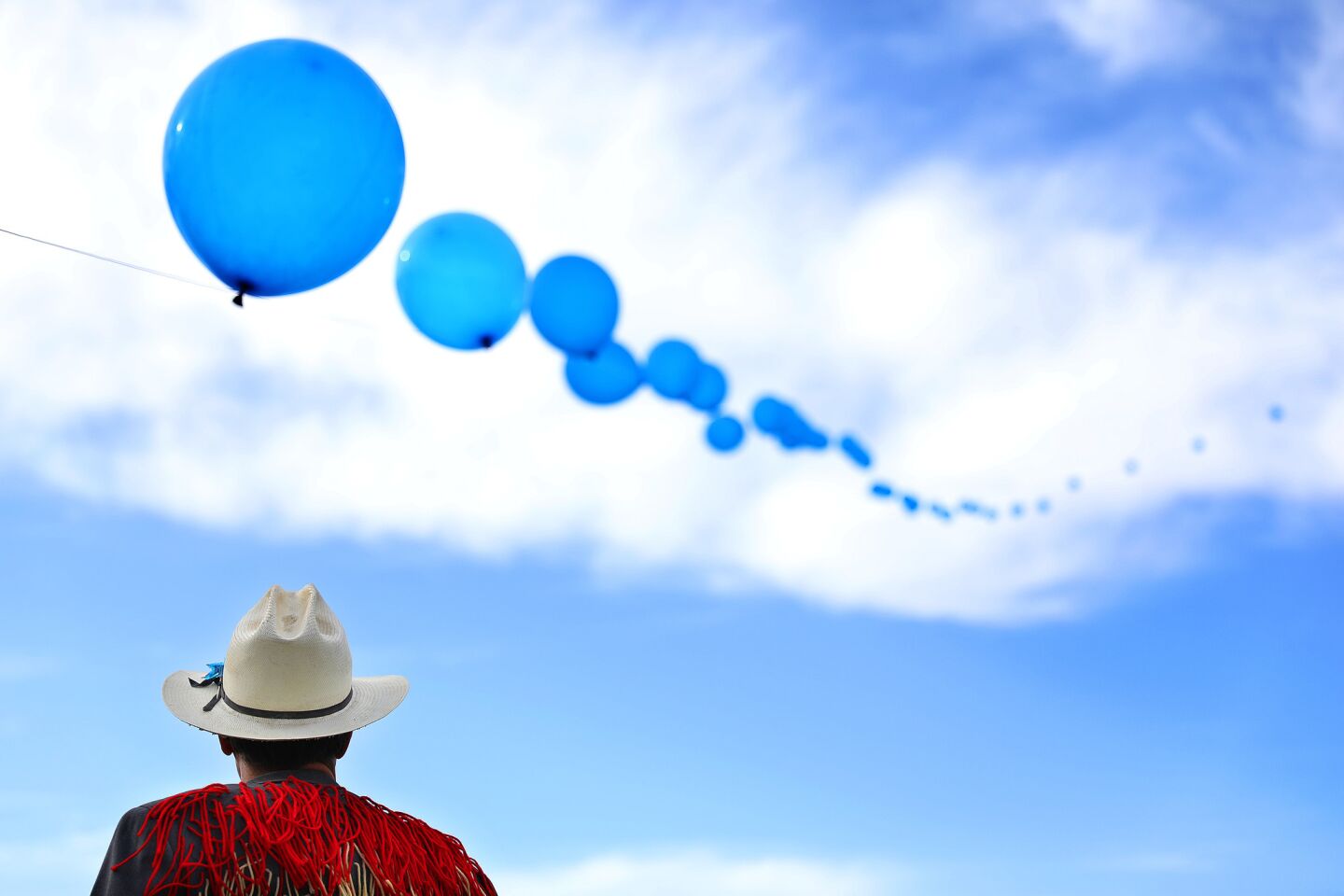 Crew member Chris Wagganer gazes up at the balloon chain that floats above Coachella.