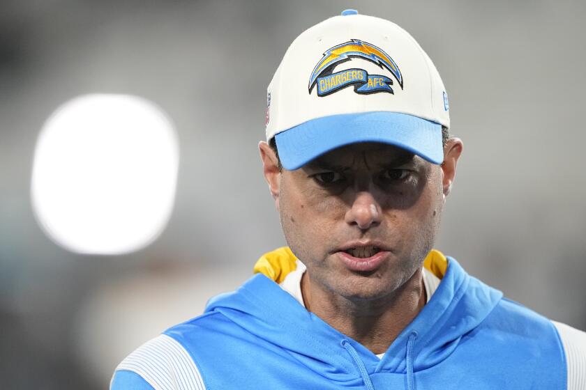 Los Angeles Chargers head coach Brandon Staley speaks to players before an NFL wild-card football game between the Jacksonville Jaguars and the Los Angeles Chargers, Saturday, Jan. 14, 2023, in Jacksonville, Fla. (AP Photo/Chris Carlson)