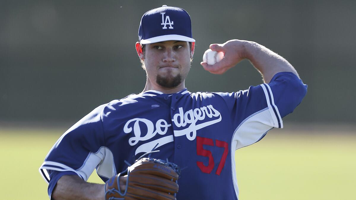 Pitcher Scott Elbert throws during a Dodgers spring training practice session on Feb. 10. Elbert has undergone three elbow surgeries in the last two years.