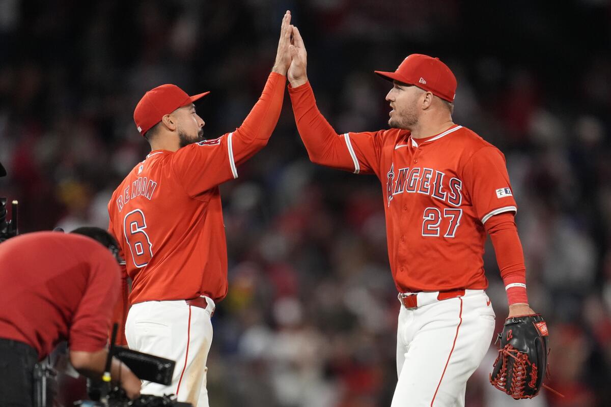 Anthony Rendon, left, and Mike Trout high-five each other after an Angels win over the Red Sox.