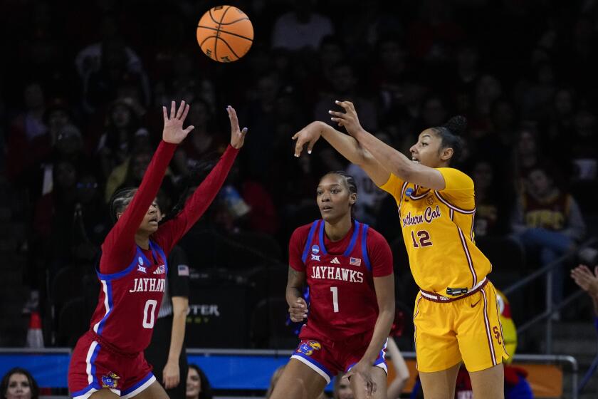 Southern California guard JuJu Watkins (12) passes against Kansas guard Wyvette Mayberry.