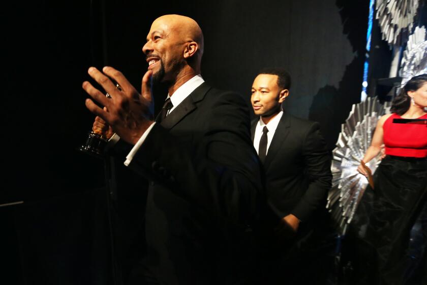 Common, left, and John Legend stand backstage at the Academy Awards. Oscar producers Craig Zadan and Neil Meron made it a priority to have the Oscars show look a little more like the people at home watching.