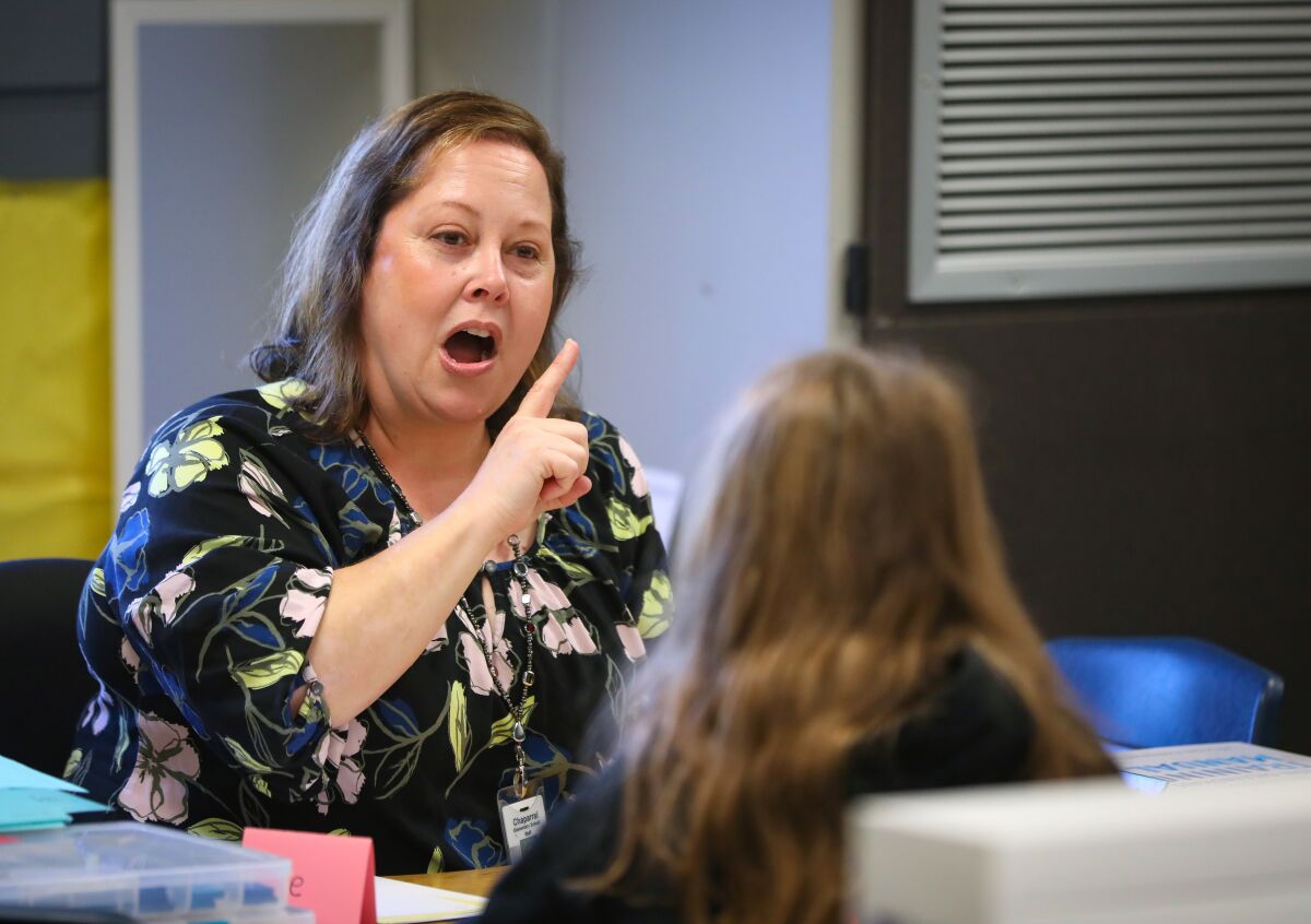 Linda Ford, a resource specialist teacher at Chaparral Elementary School in Poway Unified, goes over spelling with students using hand motions to signify different sounds on Feb. 11, 2020. Ford works with students with language-based learning disabilities, including dyslexia.