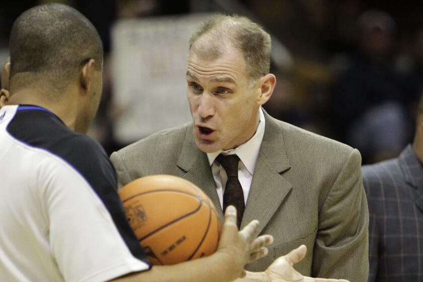 Cleveland Cavaliers assistant coach Chris Jent argues with referee Tony Brothers.
