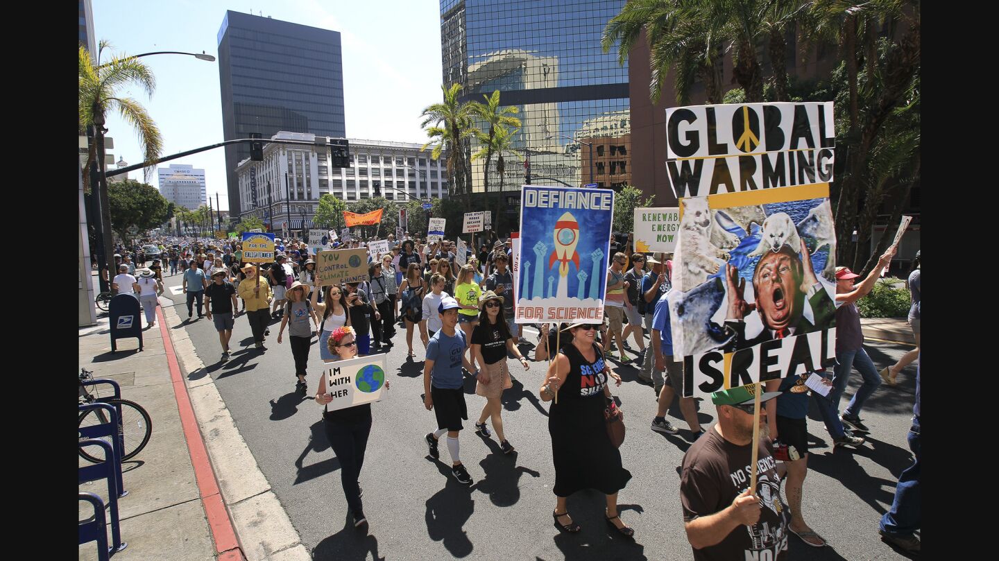 People participating in the March for Science make their way down Broadway as they head toward North Harbor Drive in downtown San Diego.