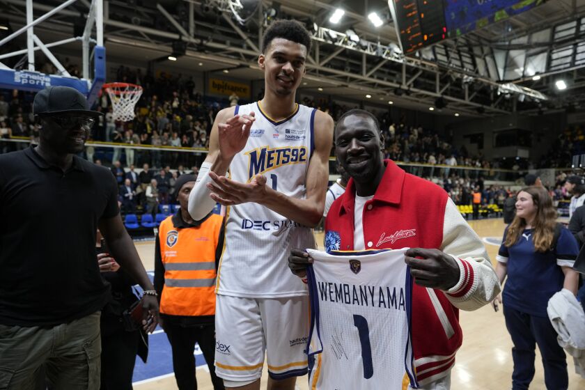 Boulogne-Levallois' Victor Wembanyama poses for a photo with French actor Omar Sy after the Elite basketball match Boulogne-Levallois against Paris at the Palais de Sports Marcel Cerdan stadium in Levallois-Perret, outside Paris, Tuesday, May 16, 2023. Wembanyam is projected to be the first overall pick in the 2023 NBA draft. (AP Photo/Thibault Camus)