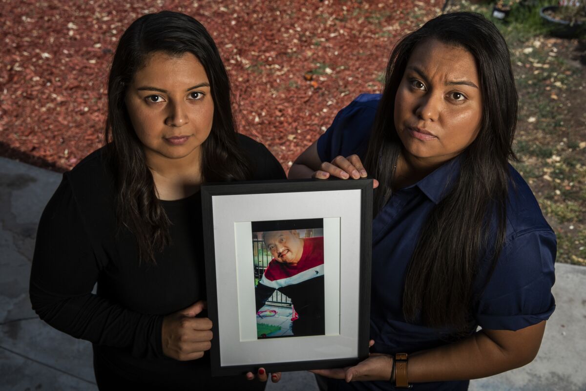 Katherine Garcia, left, and sister Johanna Garcia at their Norwalk home. They are the daughters of the late Enrique Garcia. 