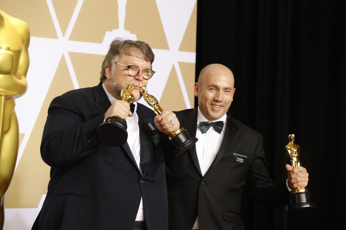 Director Guillermo del Toro, left, and producer J. Miles Dale of "The Shape of Water," pose for photos at the 90th Academy Awards.
