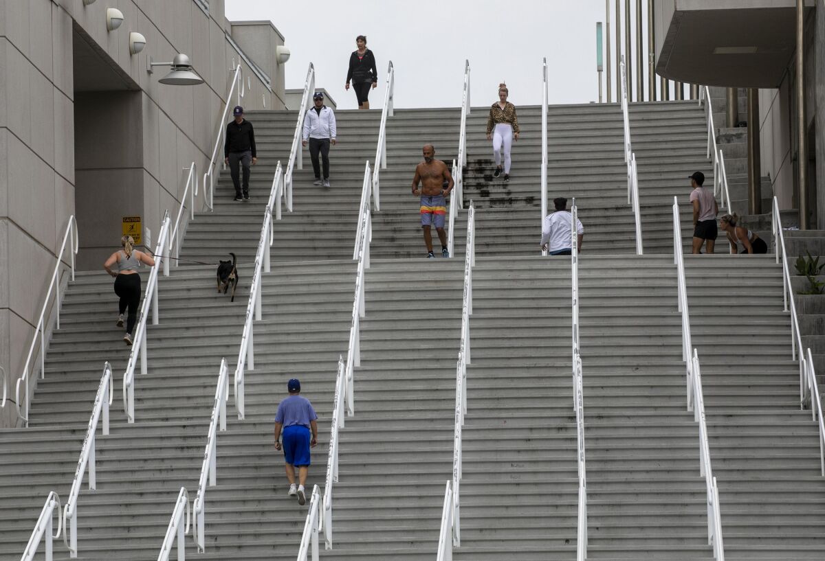 People kept their distance because of  COVID-19 while they exercised on the stairways at the Convention Center.