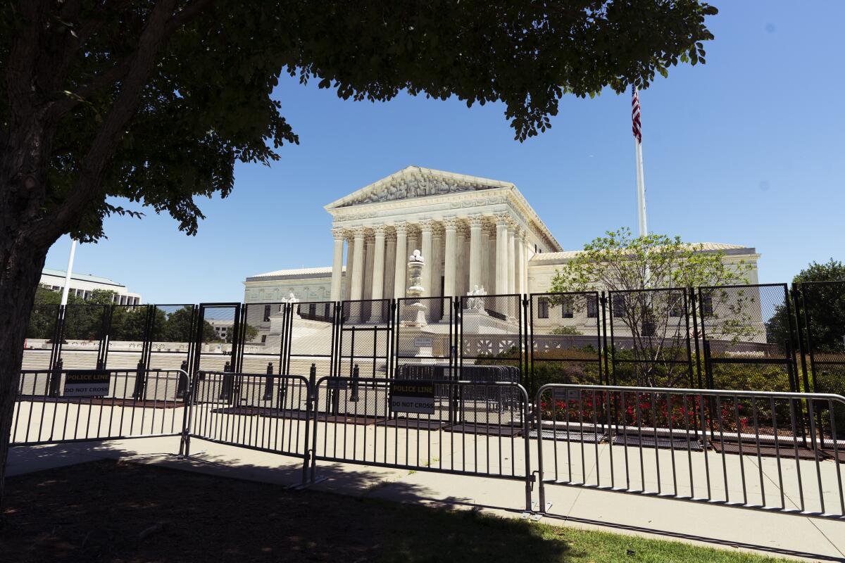 Two rows of metal security fencing surrounding the U.S. Supreme Court