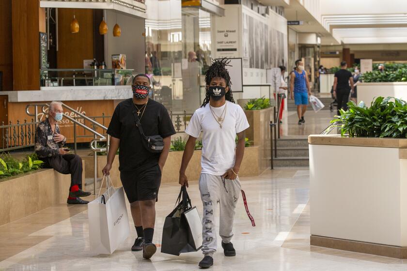 Jeff Luckey, left, and Tarique Lusk shop during the reopening of South Coast Plaza on Monday, August 31.