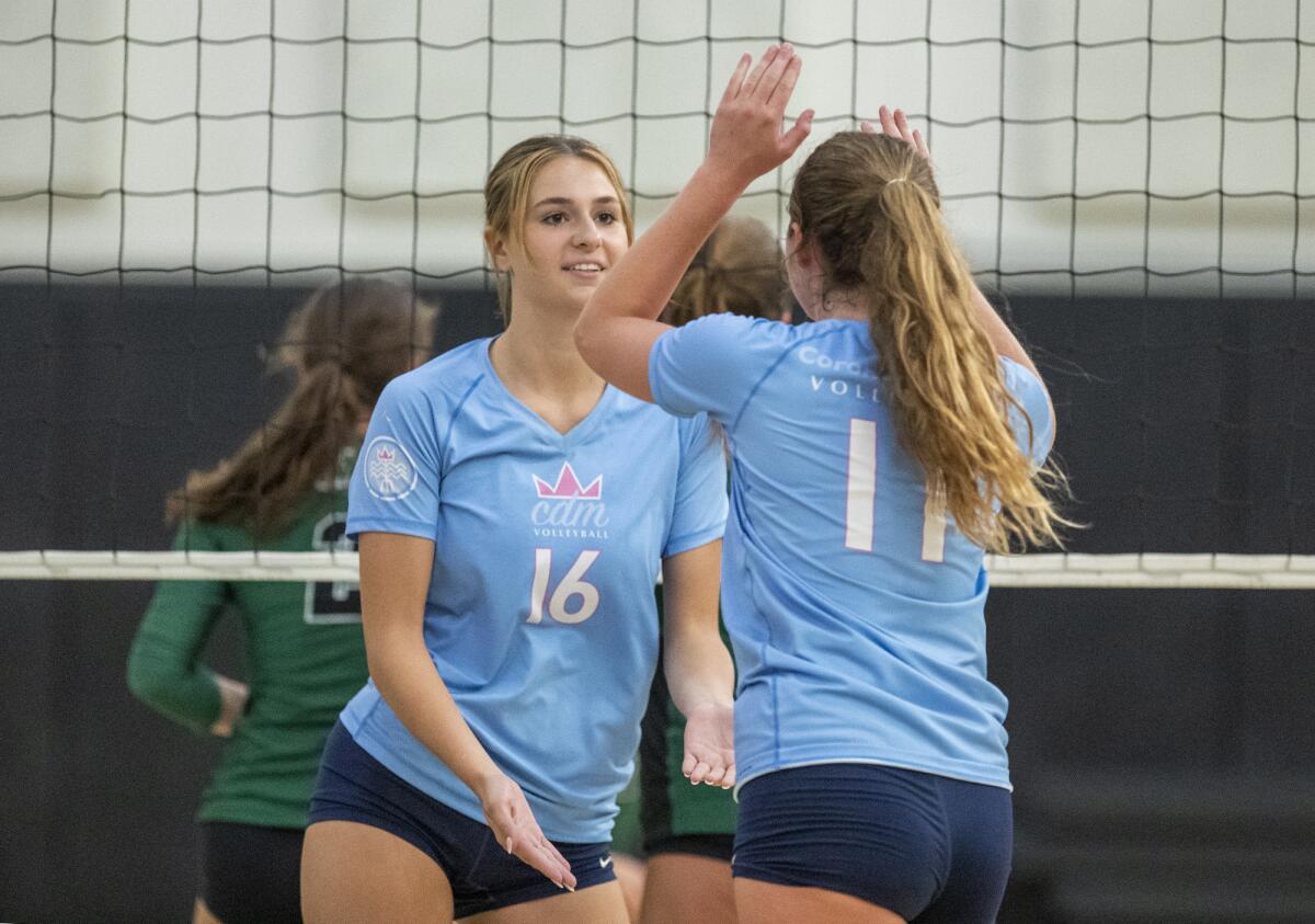 Corona del Mar's Sabrina Baker gets a high-five from Reese Olson against Sage Hill on Aug. 16 in Newport Beach.
