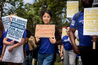 Los Angeles, CA - May 17: Daniela Valadez, a UCLA student majoring in labor studies, holds a sign that reads, "Support undocumented students! Opportunity for all!," as students and supporters gathered to support undocumented students in the University of California system, rallying and marching to protest outside a meeting of the UC Board of Regents meeting, on the UCLA Campus in Los Angeles, CA, Wednesday, May 17, 2023. The rally wants to demand the UC Board of Regents break legal ground and authorize the hiring of students who were brought to this country illegally as children and lack valid work permits. (Jay L. Clendenin / Los Angeles Times)