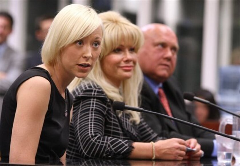 Sex workers from the Moonlite Bunny Ranch, Brooke Taylor, left, and Deanne "Air Force Amy" Salinger testify Tuesday, April 8, 2009 at the Legislature in Carson City, Nev. Bunny Ranch owner Dennis Hof, at right, was one of three brothel owners who also testified on a proposal to levy a $5 state tax on sex acts to help raise state revenue. (AP Photo/Nevada Appeal, Cathleen Allison)