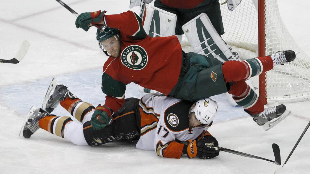 Minnesota Wild defenseman Nate Prosser falls over Ducks center Ryan Kesler during the third period of the Ducks' 5-4 win Friday.