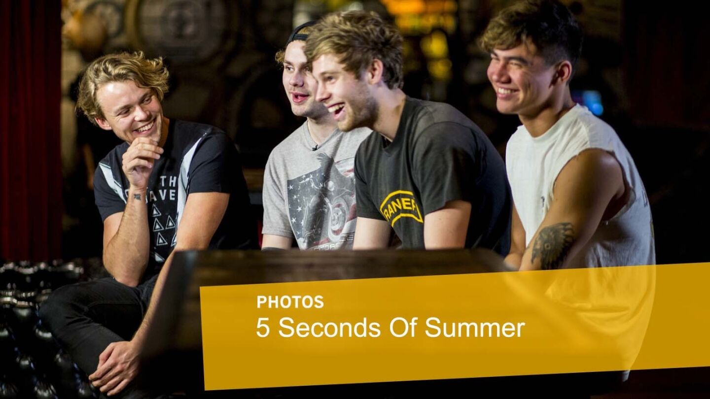 In promoting the release of their new album, "Sounds Good, Feels Good," Ashton Irwin, left, Michael Clifford, Luke Hemmings and Calum Hood of Australian pop band 5 Seconds of Summer, give TV interviews before performing at Hollywood & Highland Center and signing autographs at the Hot Topic store in Hollywood on Oct. 23, 2015.
