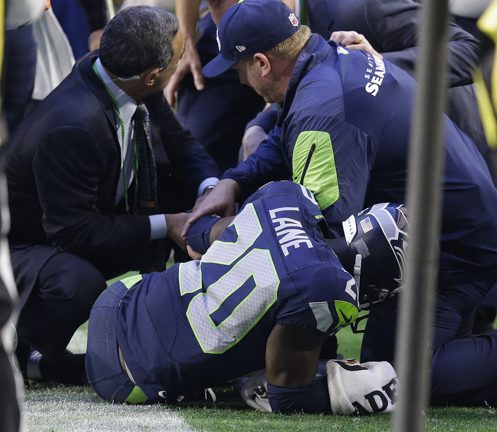 Seahawks corner Jeremy Lane (20) is tended to by trainers after suffering an elbow injury in Super Bowl XLIX.