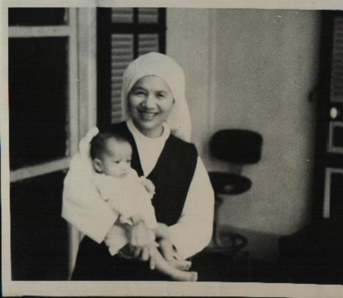 Sister Angela Nguyen holds the baby. It was at Nguyen's urging that led Bao Tran to name the girl.