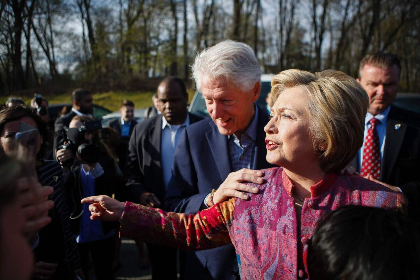 Democratic presidential candidate Hillary Clinton and her husband, former President Bill Clinton, greet supporters after casting their ballots at a polling station in Chappaqua, N.Y.