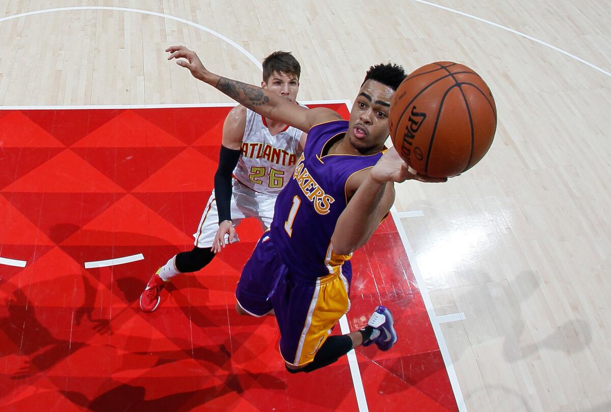 Lakers guard D'Angelo Russell shoots after getting behind the Hawks' Kyle Korver in Atlanta on Dec. 4, 2015.