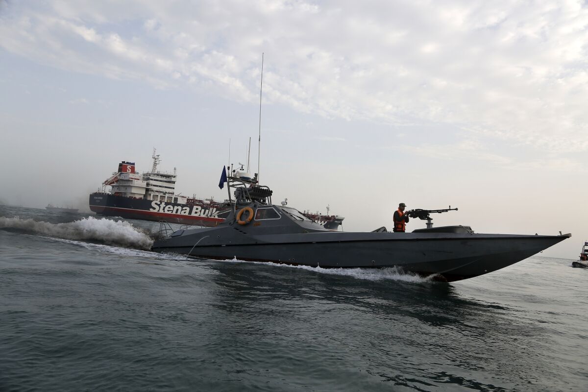 In this July 21, 2019, photo, a speedboat of the Iran's Revolutionary Guard moves around British-flagged oil tanker Stena Impero, which was seized by the Guard on July 19 in the Iranian port of Bandar Abbas.