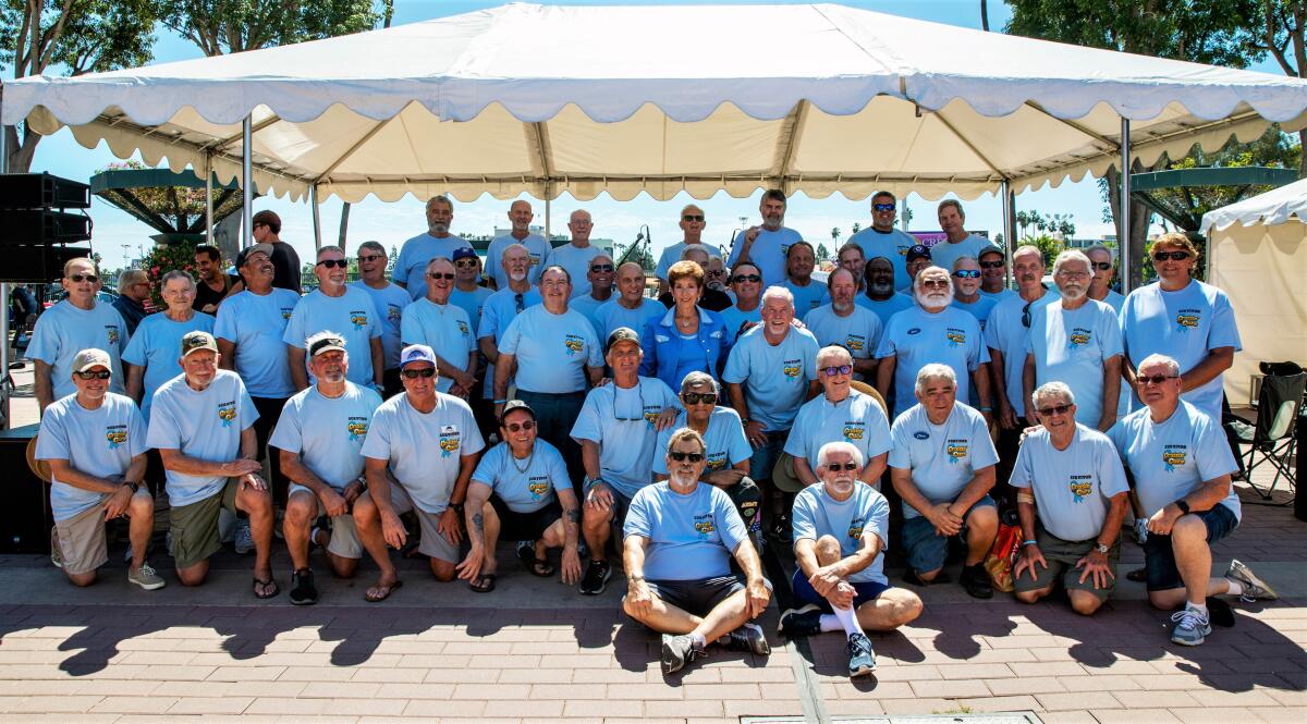 Debbie Baker, organizer of Cruisin' for a Cure, center, poses with grateful prostate cancer survivors at Saturday's event.