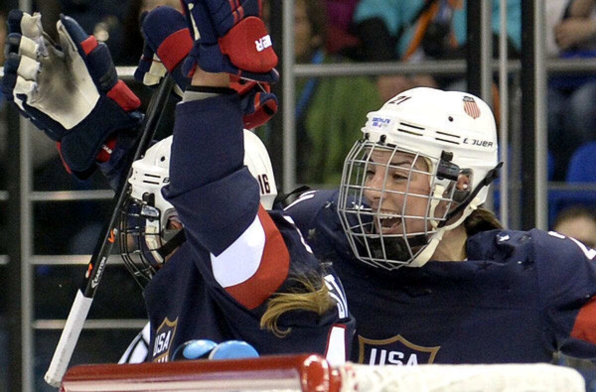 Americans Kelli Stack (16) and Hilary Knight celebrate after a goal by Stack against Finland in a preliminary round game on Saturday.