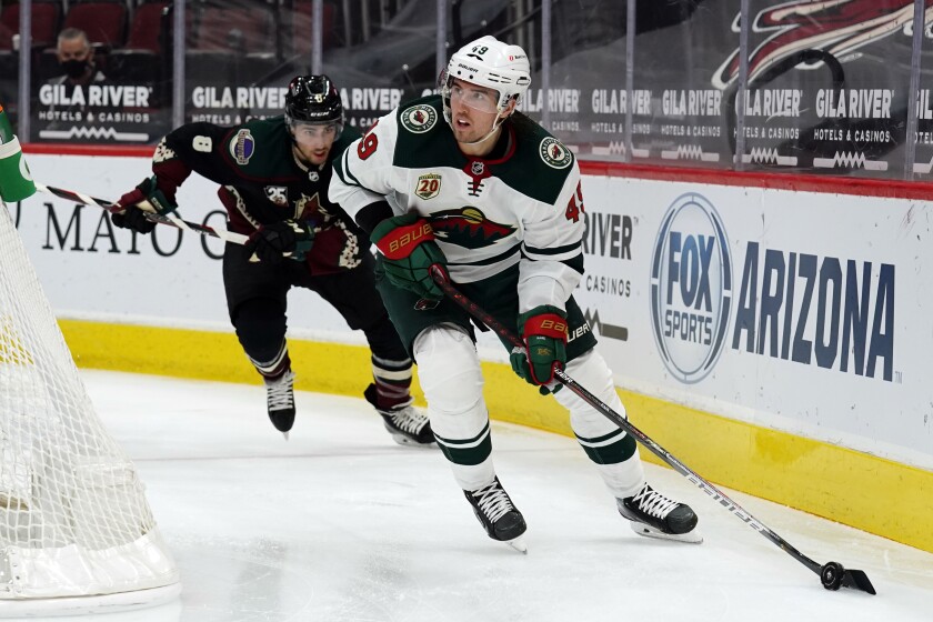 Minnesota Wild center Victor Rask (49) skates away from Arizona Coyotes center Nick Schmaltz during the second period of an NHL hockey game Friday, March 5, 2021, in Glendale, Ariz. (AP Photo/Rick Scuteri)
