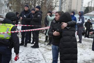 People react at the site of a Russian attack in Kyiv, Ukraine, Tuesday, Jan. 23, 2024. (AP Photo/Efrem Lukatsky)