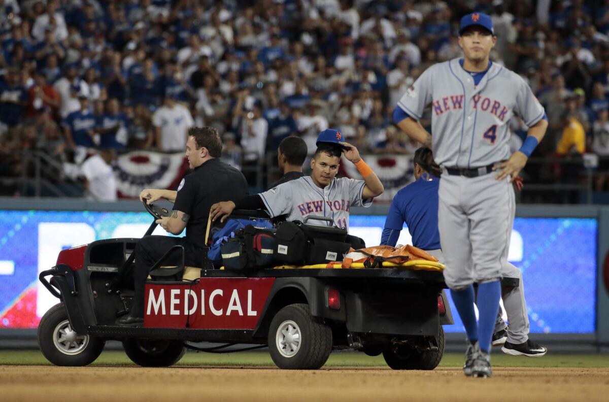 Mets shortstop Ruben Tejada is carted off the field with a leg injury after Dodgers baserunner Chase Utley collided with him to break up a potential double play in the seventh inning.