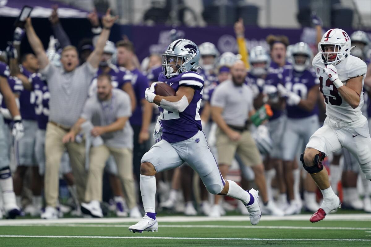 Kansas State running back Deuce Vaughn (22) sprints past Stanford cornerback Ethan Bonner (13) on his way to the end zone for a touchdown in the first half of an NCAA college football game in Arlington, Texas, Saturday, Sept. 4, 2021. (AP Photo/Tony Gutierrez)