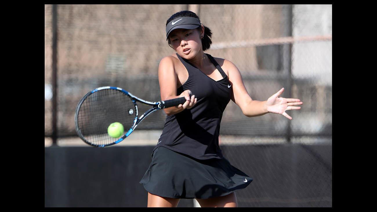 Glendale High School girls tennis singles player Kristen Lee returns the ball in game vs. Burroughs High school player Sandy LeMay, at home in Glendale on Tuesday, Sept. 25, 2018