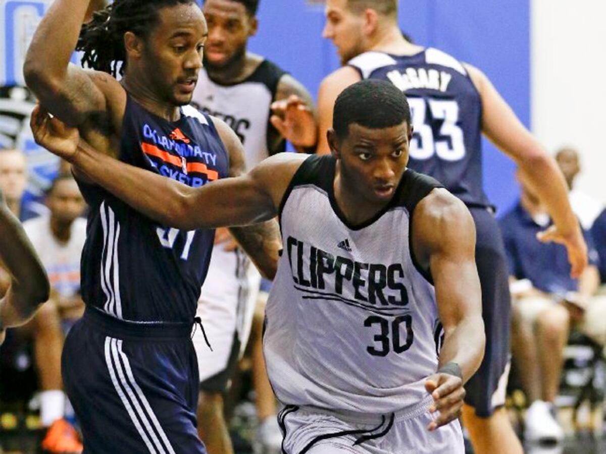 Clippers guard C.J. Wilcox works his way around Oklahoma City guard Levi Randolph, left, during the second half of an NBA summer league game Tuesday in Orlando.