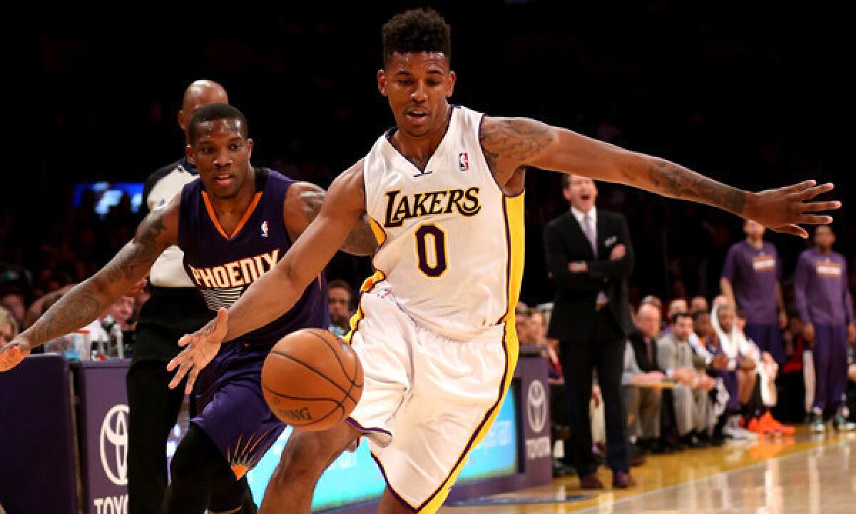 Lakers small forward Nick Young, right, drives past Phoenix Suns point guard Eric Bledsoe during the Lakers' 115-99 win Sunday at Staples Center.