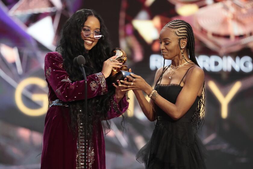 Los Angeles, CA, Sunday, March 14, 2021 - H.E.R. and Tiara Thomas accepts the award for Song Of The Year at the 63rd Grammy Award outside Staples Center. (Robert Gauthier/Los Angeles Times)