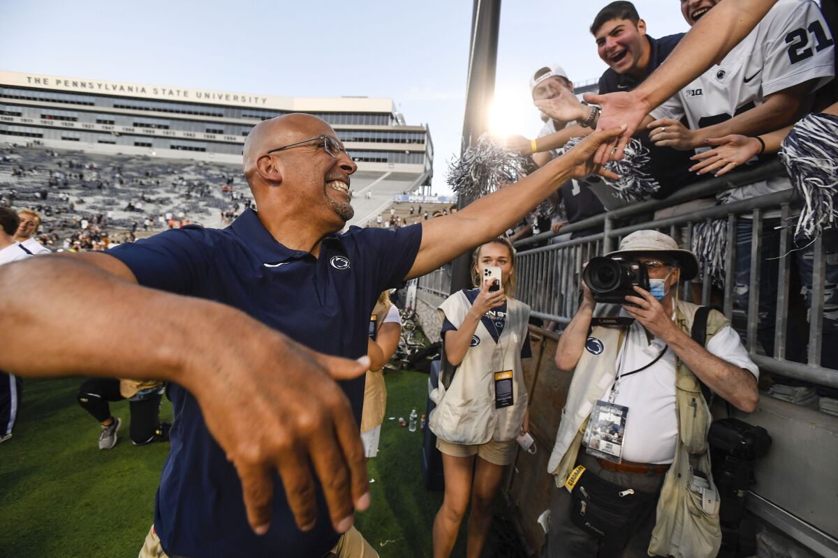 Penn State coach James Franklin shakes hands with fans in the stands following a 44-13 victory over Ball State 