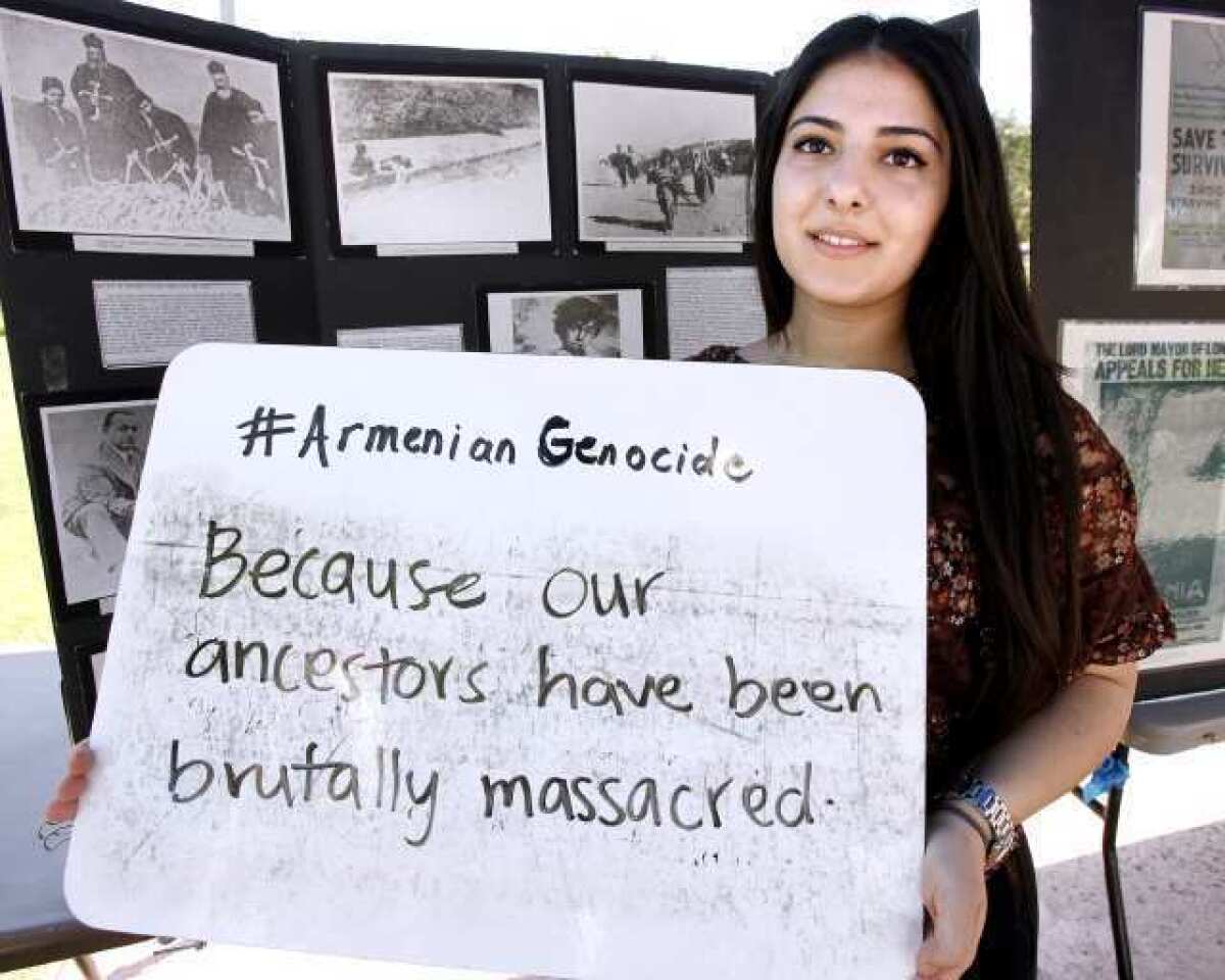 Marine Mary Mkhsyan, 18 of Glendale, shows her answer to the question "Should President Obama recognize the Armenian Genocide?" at Glendale Community College on Tuesday, April 23, 2014. The Armenian club at GCC held an outdoor exhibit about the genocide.