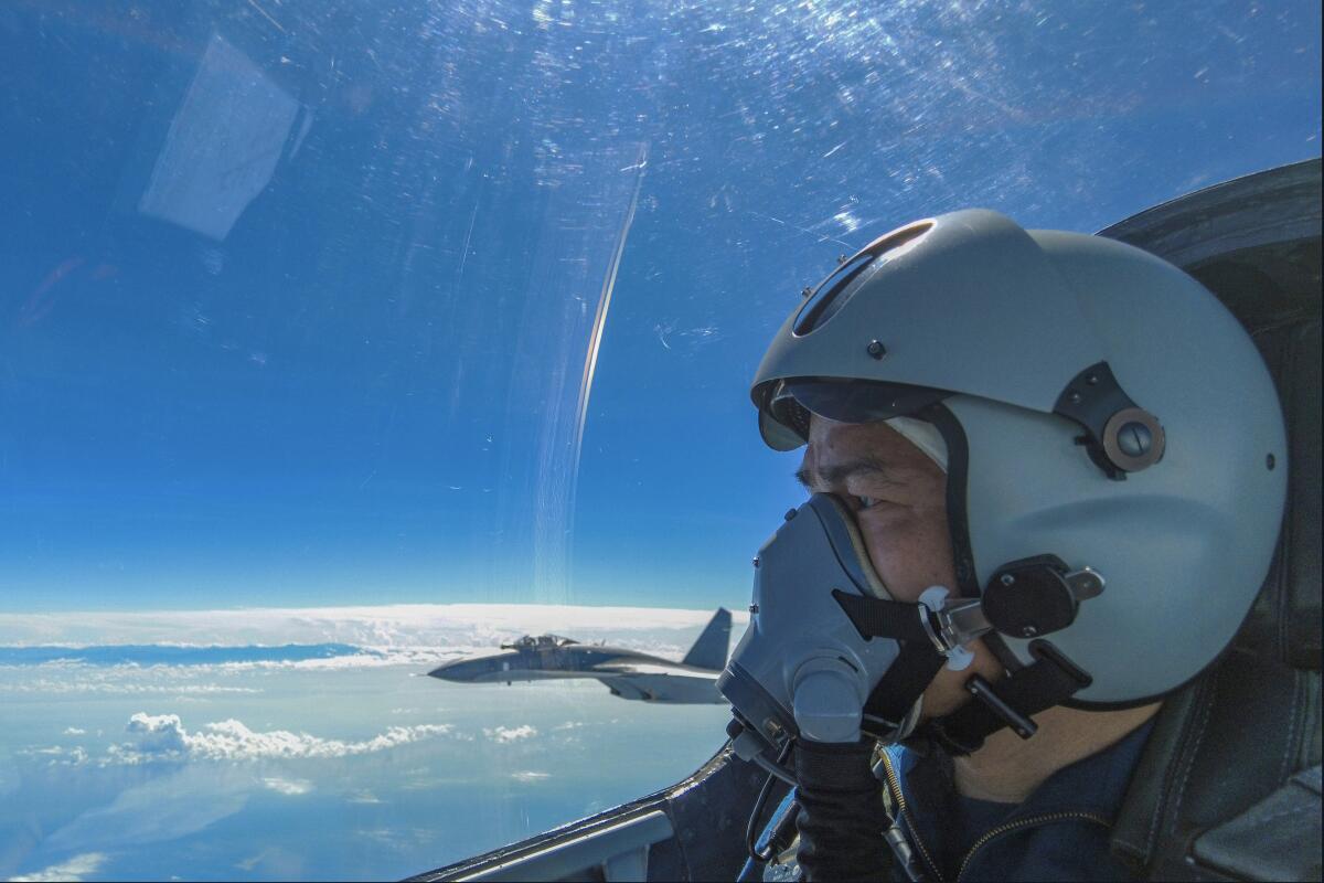 In this photo released by Xinhua News Agency, an air force pilot from the Eastern Theater Command of the Chinese People's Liberation Army (PLA) looks as they conduct a joint combat training exercises around the Taiwan Island on Sunday, Aug. 7, 2022. China said Monday it was extending threatening military exercises surrounding Taiwan that have disrupted shipping and air traffic and substantially raised concerns about the potential for conflict in a region crucial to global trade. (Wang Xinchao/Xinhua via AP)