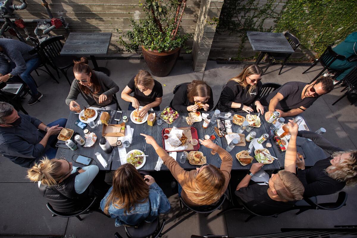 An aerial view of a group of people eating at a table.
