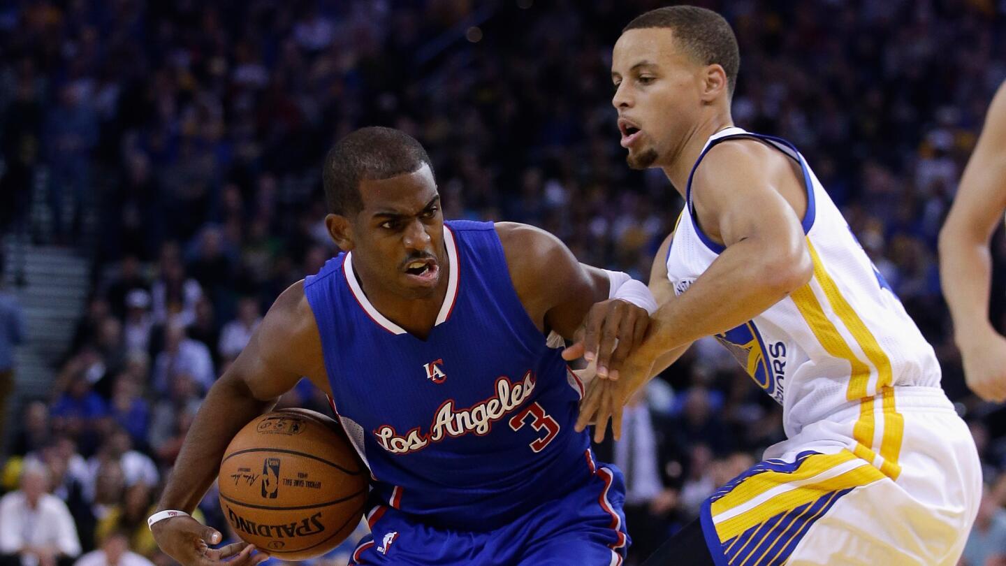 Clippers point guard Chris Paul, left, tries to drive past Golden State Warriors point guard Stephen Curry during the first half of a Nov. 5 game.