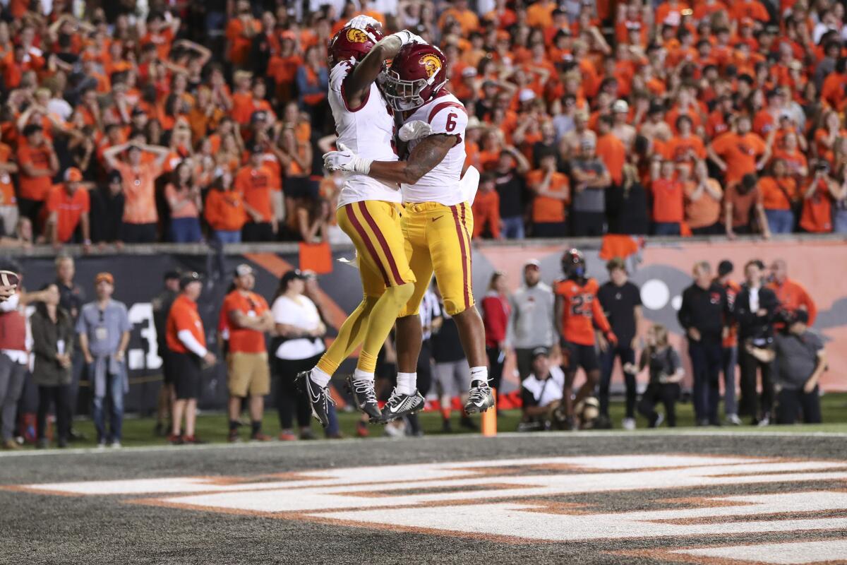 USC receiver Jordan Addison celebrates his touchdown catch by jumping in the air with running back Austin Jones.