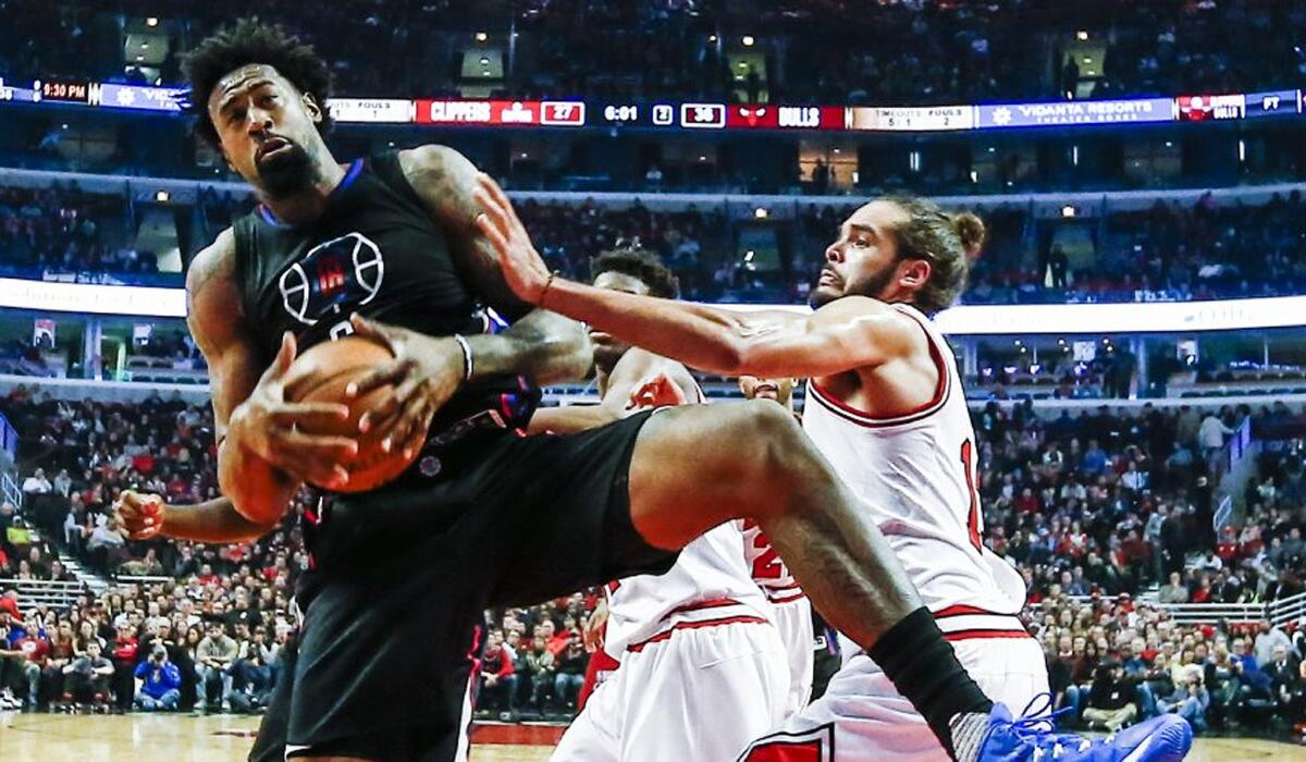 Clippers center DeAndre Jordan, left, grabs a rebound next to Bulls center Joakim Noah in the first half on Thursday.
