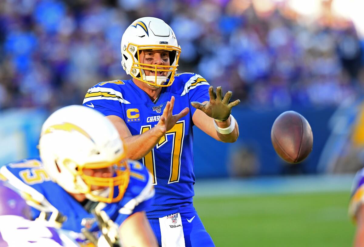 Chargers quarterback Philip Rivers takes a snap against the Vikings.