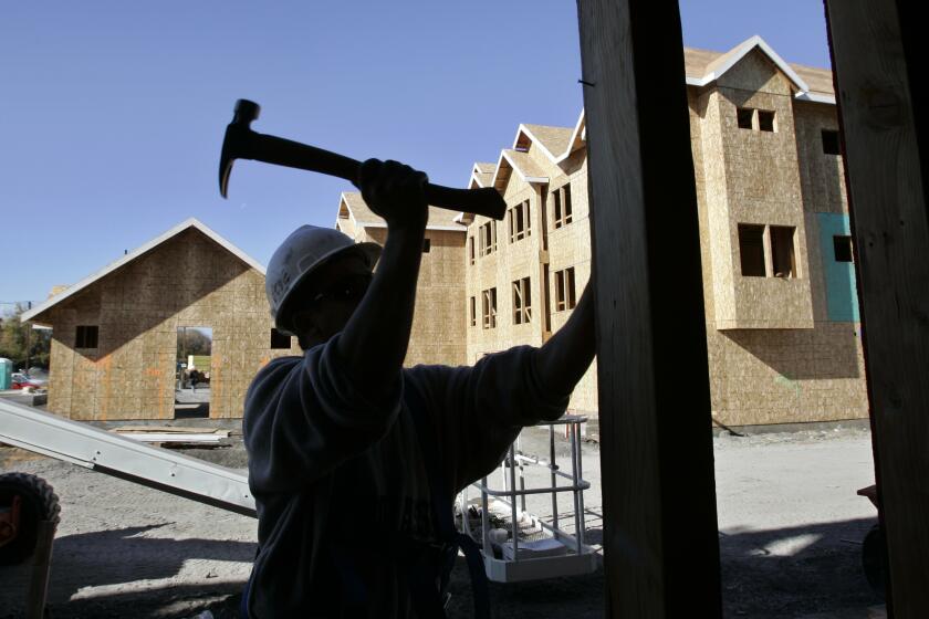 ** FILE ** In this Nov. 30, 2007, file photo, a construction worker helps builds a condo project in Mountain View, Calif. Construction spending edged up slightly in November as a continued steep slump in housing was offset by record spending on government and business projects. (AP Photo/Paul Sakuma, File)
