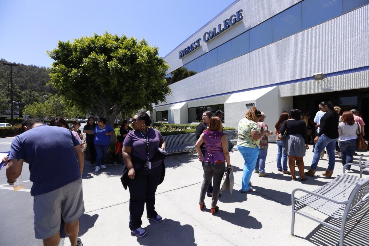 Teachers line up to collect their personal items after Everest College in the City of Industry -- one of more than two dozen campuses owned by the Corinthian Colleges system -- closed suddenly in April 2015.