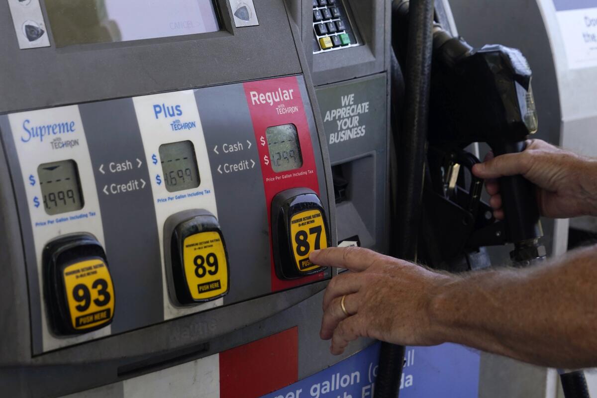 A customer pumps gas at an Exxon gas station, Tuesday, May 10, 2022, in Miami. 