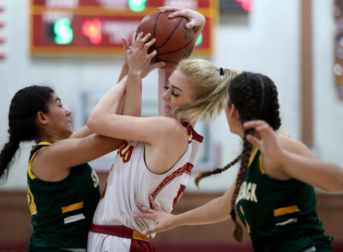 Ocean View's Helen Reynolds, center, battles for the ball against two Saddleback players in the Premiere Flight championship game of the Hawk Holiday Classic at home on Dec. 8, 2018.