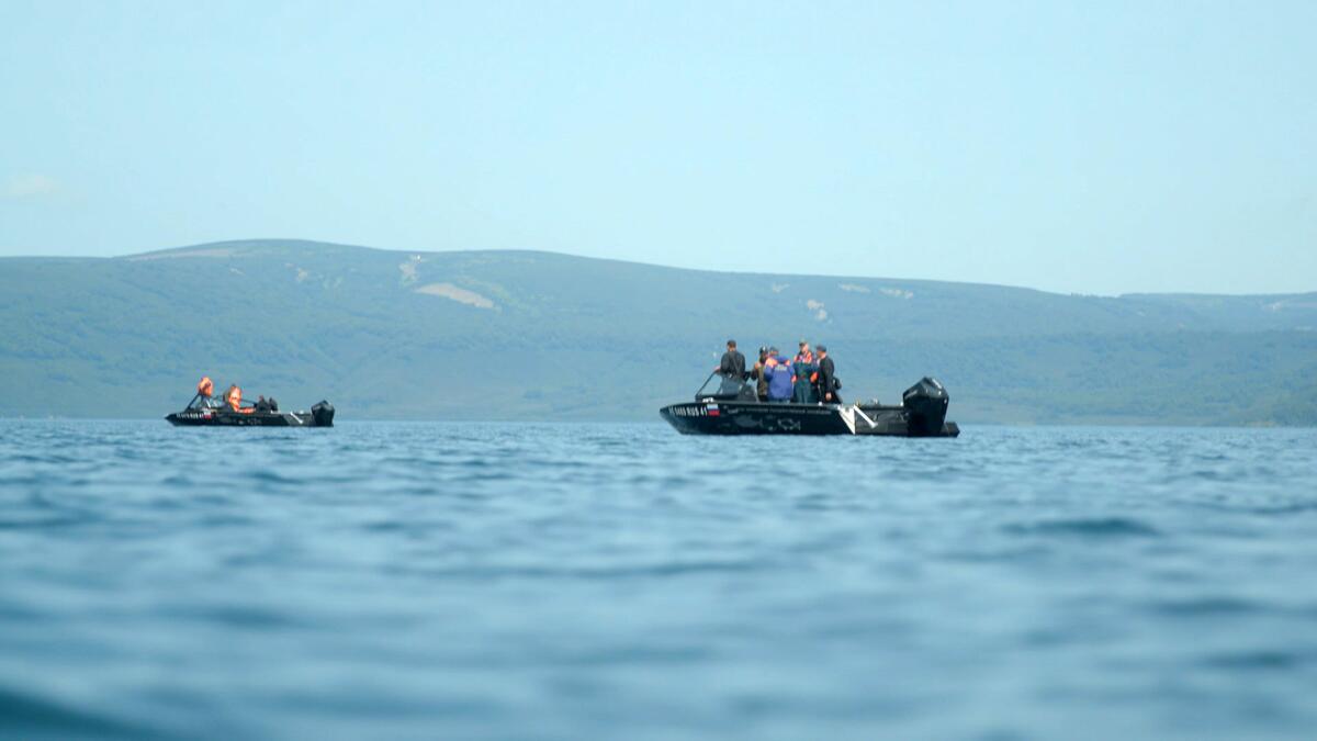 Rescue workers in boat on lake