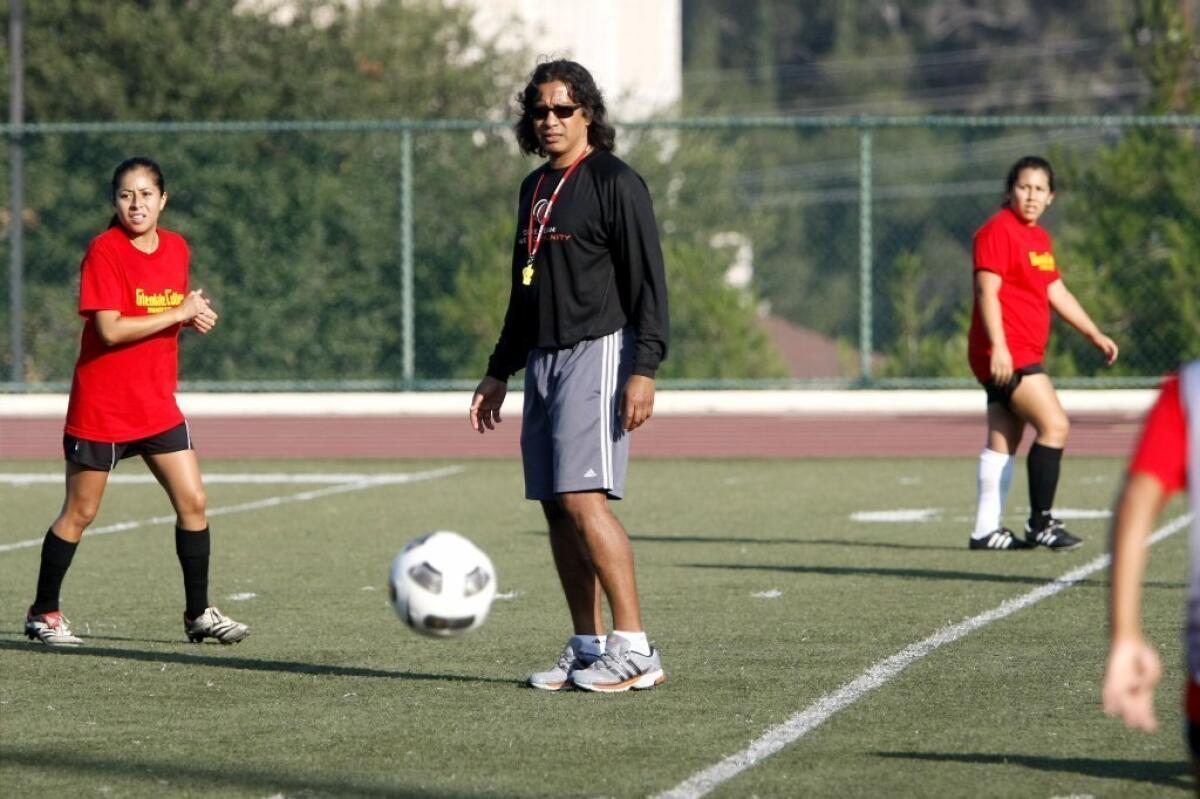 Glendale Community College women's soccer Coach Jorge Mena keeps a close eye on the action during practice.