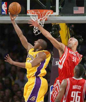 Lakers guard Kobe Bryant scores two of his 20 points in the first half with a reverse layup past Rockets forward Shane Battier on Tuesday night.